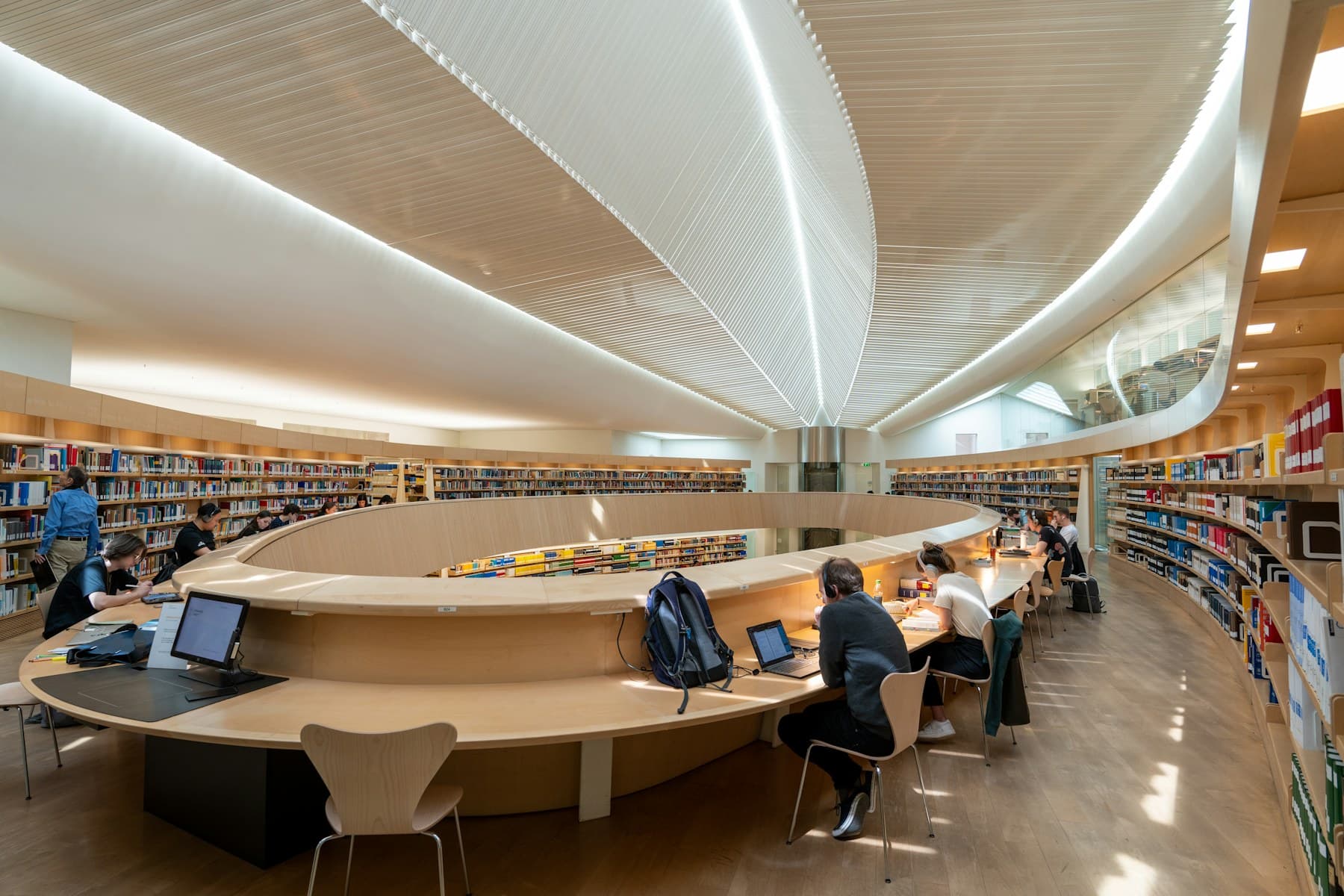 Students reading and working inside a university library